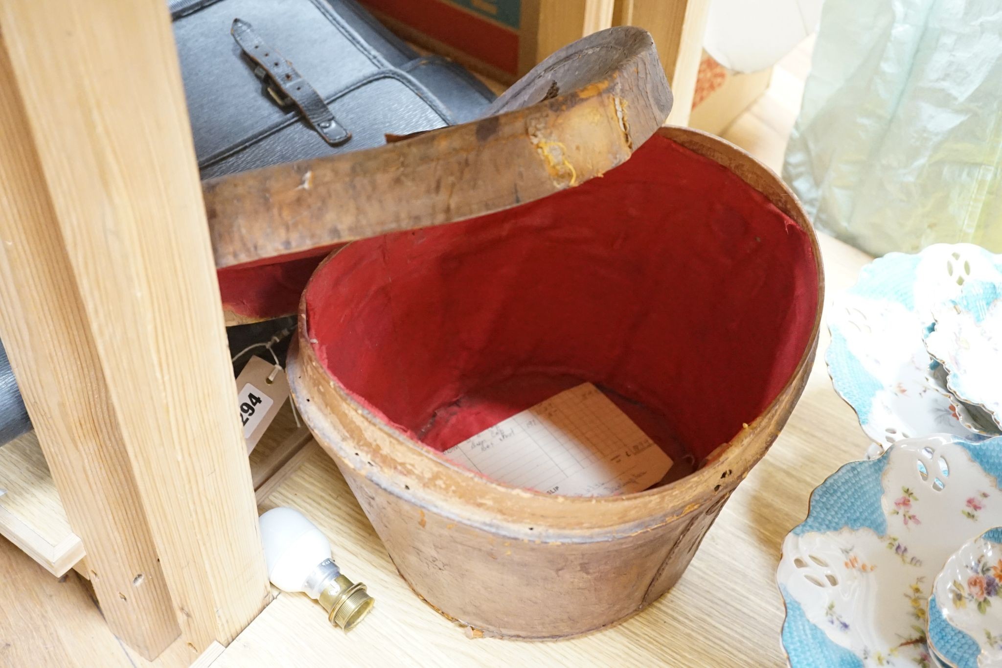 Two army officers' caps in brown leather hat box.
